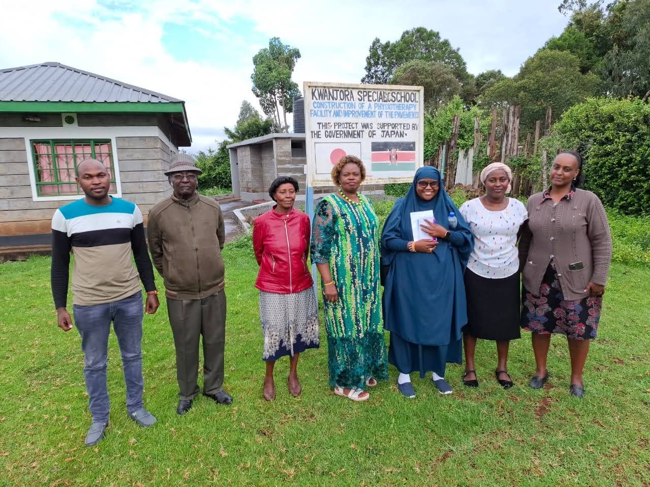 Beautiful Minds Network team outside Kwanjora Special School with staff and community members