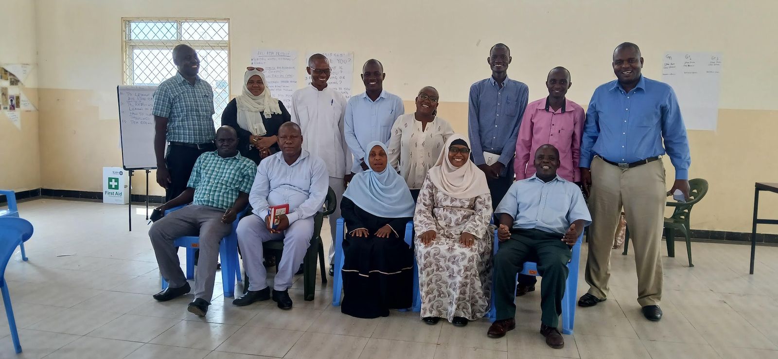 Group photo of facilitators and community leaders after a training session